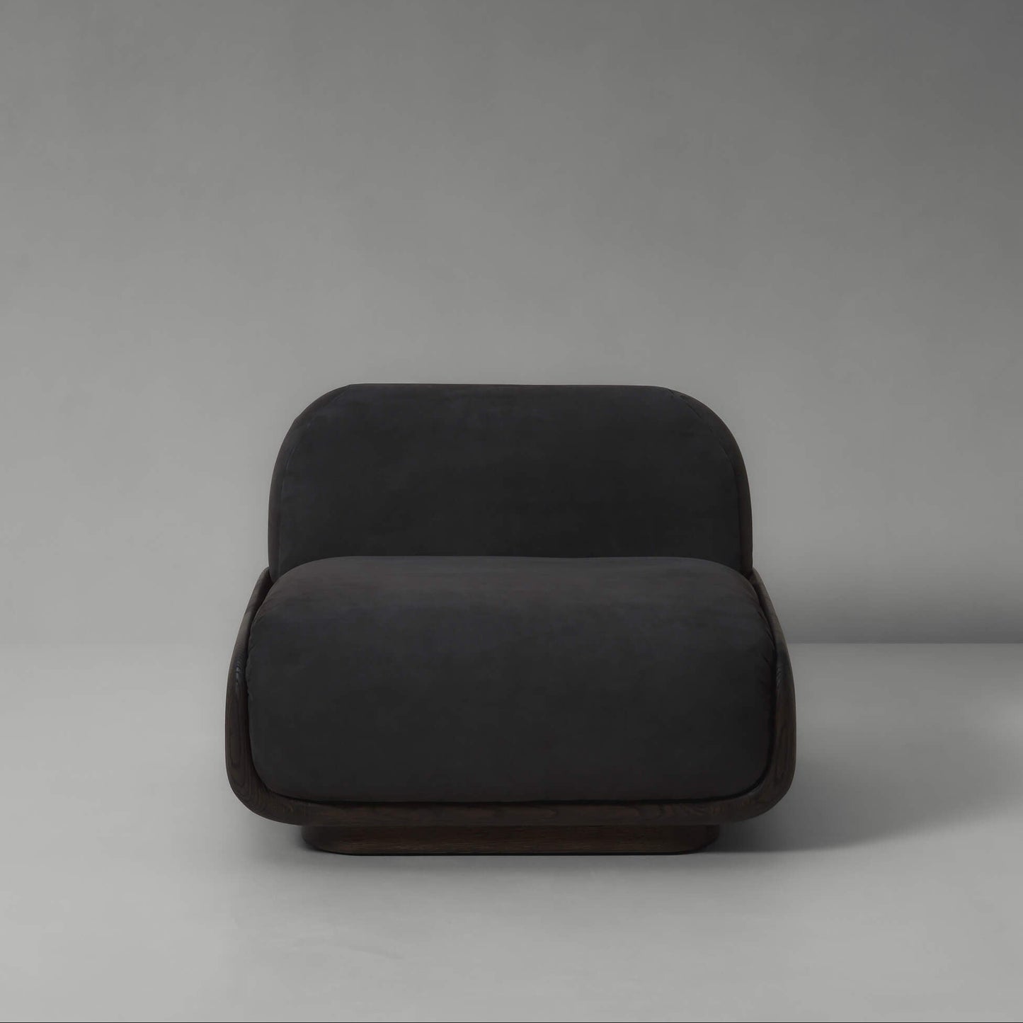 Dark gray armchair on a plain background